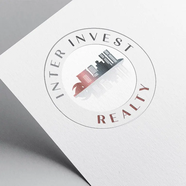 Az Inter Invest Realty ingatlaniroda logója kör elrendezésben, Tenerife fővárosára jellemző épületekkel.